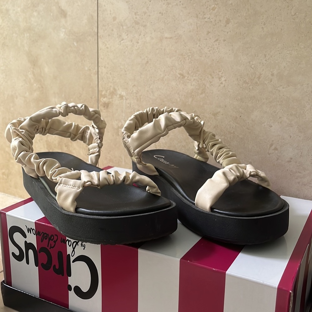 Leather sandals, cream leather ankle wrap on a black platform